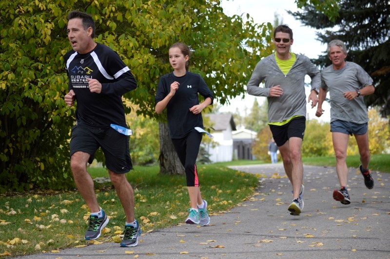 Tony Martinez, his daughter Emily, Murray Elliott and Jack Hawkings participate in the Terry Fox Run in Olds on Sept. 20. About 30 people participated in the run, raising
