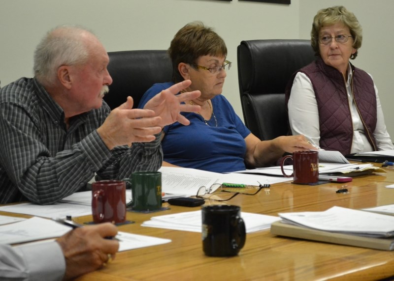 Bowden councillor Wayne Milaney, left, outlines his views on the idea of reserving parking at the arena for staff. Looking on are councillors Sandy Gamble, centre, and Sheila 