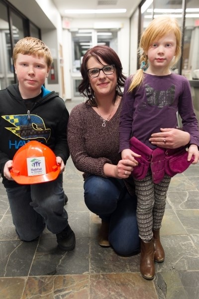 From left, Tyson Pratt, Brandy Hodgson and Taya Pratt look forward to moving into their new home, a Habitat For Humanity duplex. Construction on that home is expected to