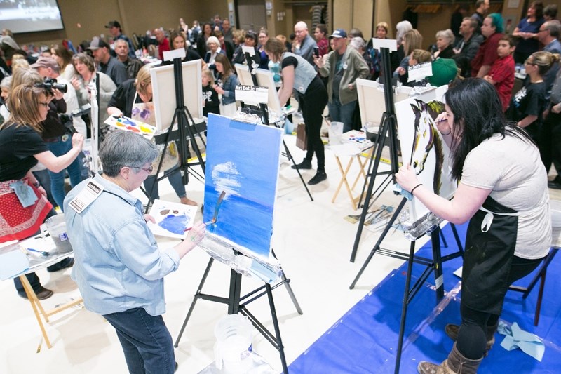 Six artists compete in the first round of Art Battle.