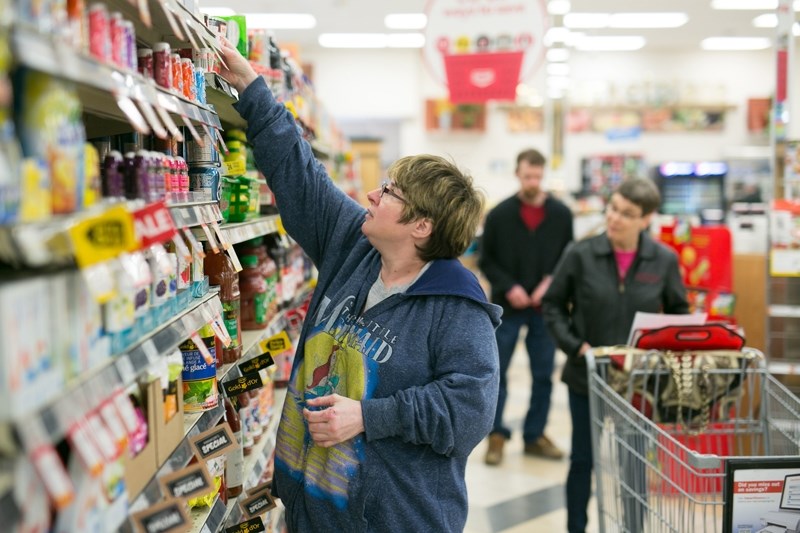 Lona Thompson collects food items from a list at Westview Co-op.