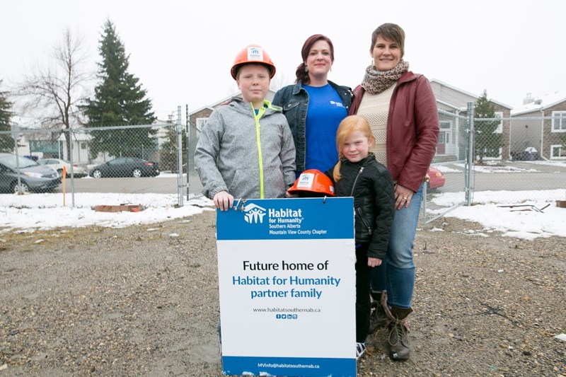 From left, Tyson Pratt, Brandy Hodgson, Taya Pratt and Amy Christianson, the family services chair for the Mountain View chapter of Habitat for Humanity, stand at the