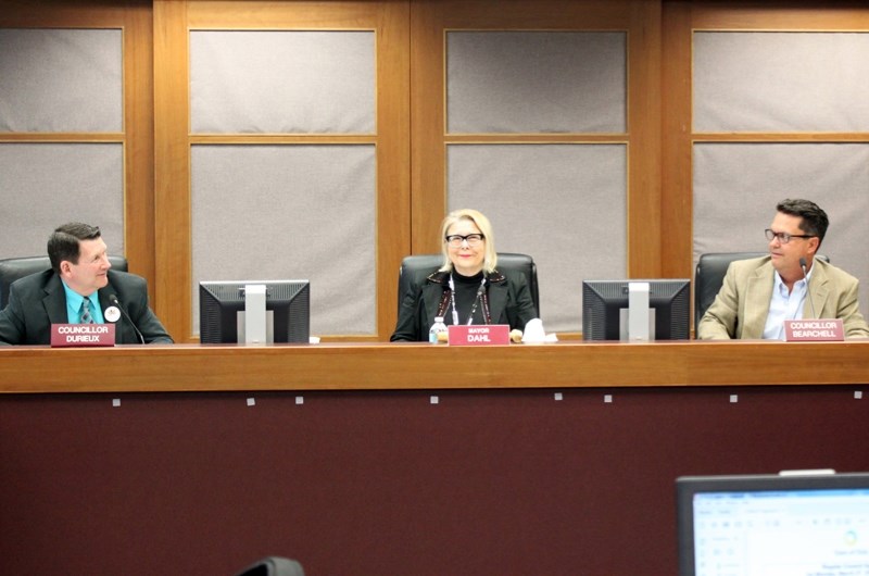 Mayor Judy Dahl takes her place front and centre while councillors Randy Durieux, left, and Wade Bearchell exchange a glance before a recent town council meeting.