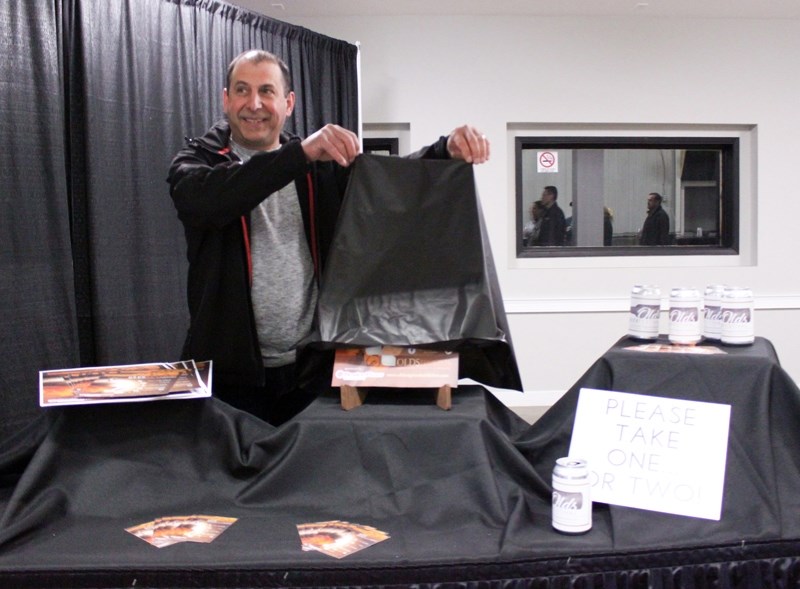 Organizing committee member Gary Gaudette unveils the offical poster for the second annual Olds Beer Festival, which will take place at the Cow Palace June 24. This year it