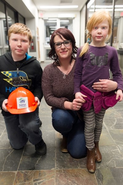 Brandy Hodgson (centre) and her children Tyson (left) and Taya Pratt have completed the sweat equity to enable them to move into their new Habitat For Humanity home when