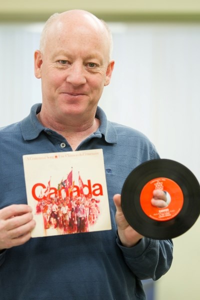 Dan Singleton holds the original Ca-na-da single and colourful cover owned by Joy Casselman.