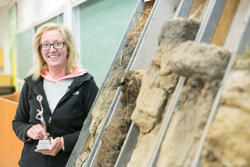Olds College instructor Nikki Cook with some soil monoliths at the college.