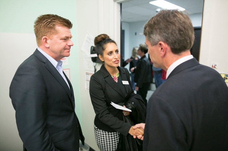 Wildrose Party Leader Brian Jean, left, and the party&#8217;s education critic, Leela Aheer, talk with Chinook&#8217;s Edge School Division superintendent Kurt Sacher during