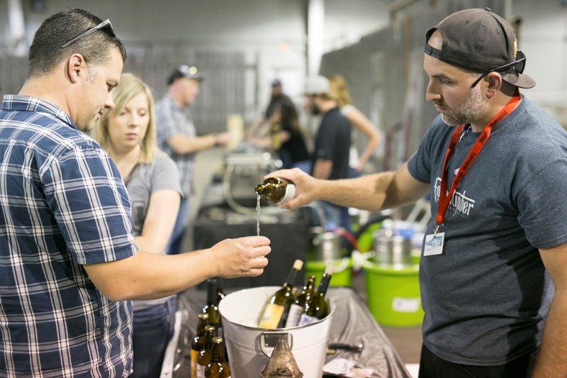 Dan Molyneux of the Fallentimber Meadery pours a sample for attendees during the second annual Olds Beer Festival at the Olds Cow Palace on June 24.