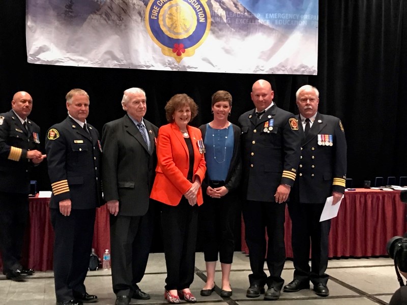 Olds Fire Dept. training Officer Justin Andrew received a 20-year exemplary service medal during the Alberta Fire Chiefs Association (AFCA) conference in Red Deer. From left