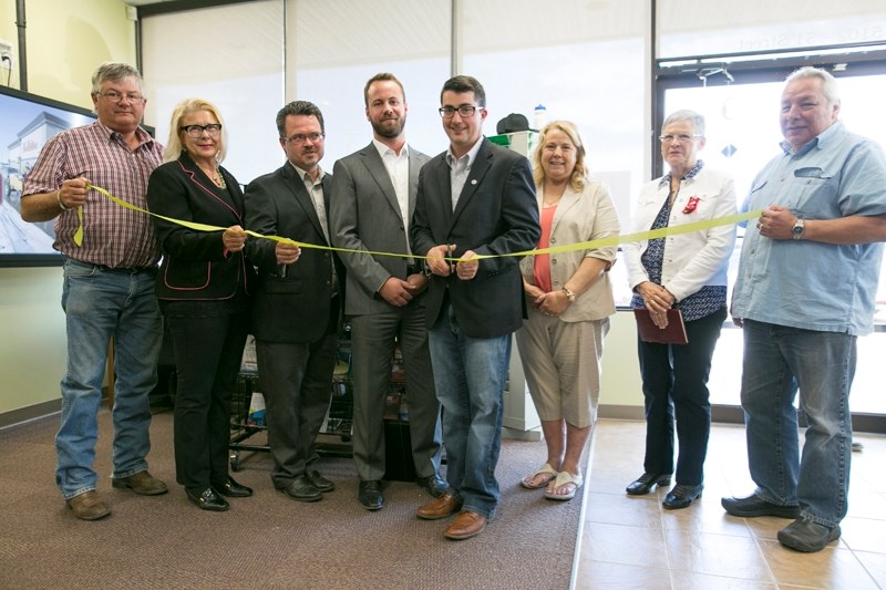 MAKING THE CUT &#8211; From left, Duncan Milne, Mountain View County councillor; Judy Dahl, mayor of the Town of Olds; Mitch Thomson, executive director of Olds Institute;