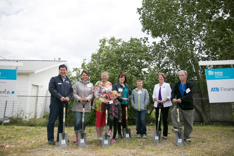 From left, Habitat for Humanity Southern Alberta president Gerrad Oishi, Habitat for Humanity Mountain View chapter family services chair Amy Christiansen, Mayor Judy Dahl,