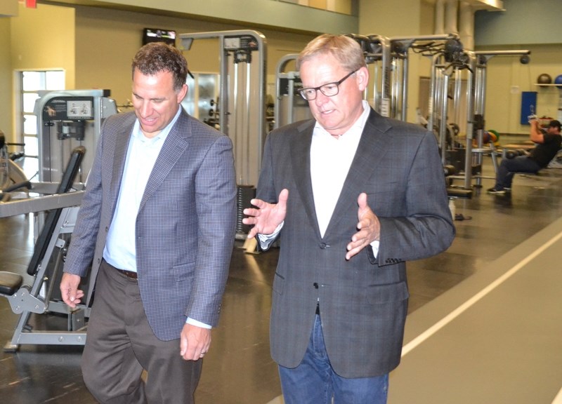 As they tour the gym in the Ralph Klein Centre, Olds College president Stuart Cullum, left, listens as Education Minister David Eggen discusses ways in which the provincial