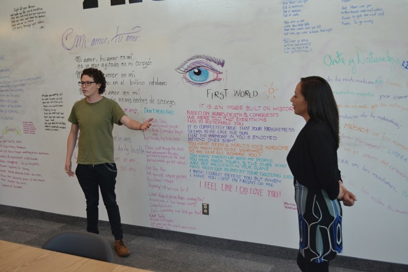 Mexican student Ricardo Garcia Galindo, left, and translator Maria Escobar discuss his poem First World with about 20 people gathered in the Olds College Learning Resources