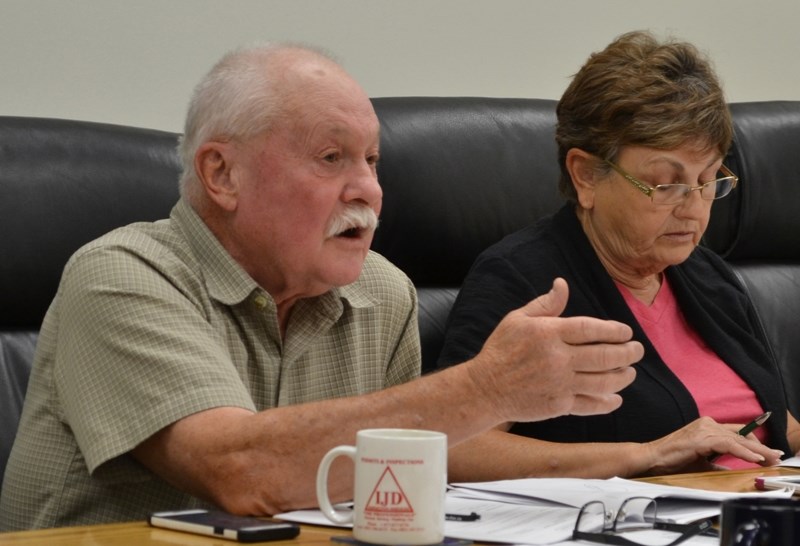 Bowden councillor Wayne Milaney, left, defends the town&#8217;s daily noon siren as fellow councillor Sandy Gamble peruses information.