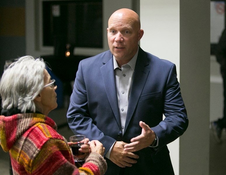 Incoming Olds mayor Michael Muzychka speaks with Thelma Hilton Wenc during a meet-and-greet at the Olds Cow Palace.