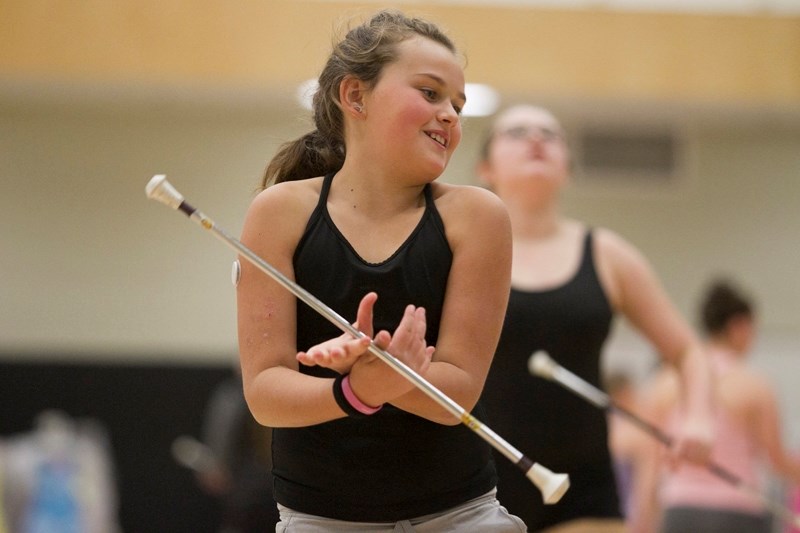 Natasha Tarrant works on a routine during a baton twirling clinic at Olds High School.