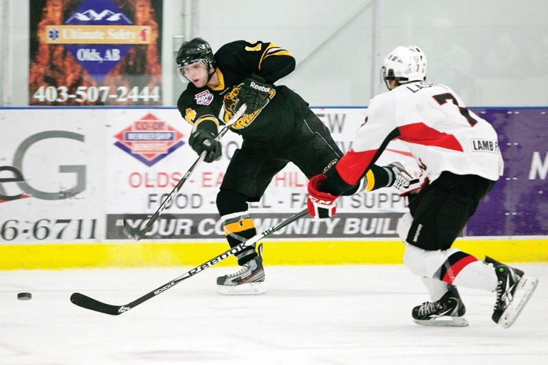 Grizzlys player Bart Moran passes the puck during their game against the Camrose Kodiaks last Friday at the Olds Sportsplex. The Grizzlys won 4-2.