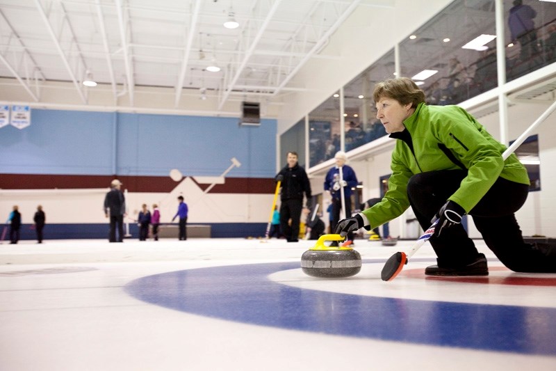 Betty Richardson releases a rock last Thursday during the Olds Farmers and Farmerettes Bonspiel at the Olds Curling Club . The event ran from Feb. 14 to 18.