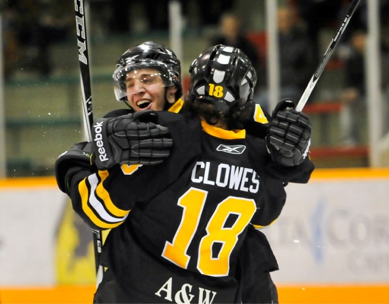 Grizzlys players Brandon Clowes and Casey Rogers celebrate the second Grizzlys goal of the game as the Olds Grizzlys take on the Maclin Ford Mustangs in the first round of