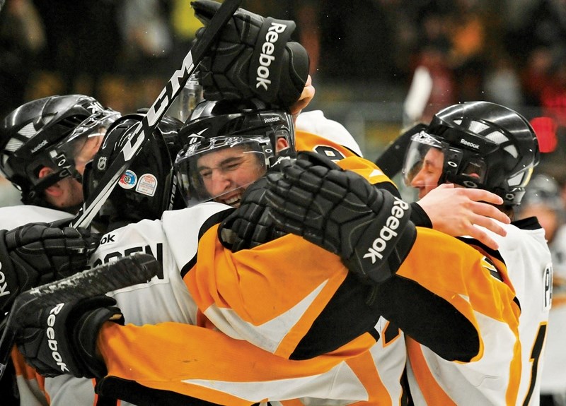 The Olds Grizzlys celebrate their 4-3 victory over the Okotoks Oilers Thursday night. They move on to play the Brooks Bandits in the AJHL semi-finals beginning Friday in