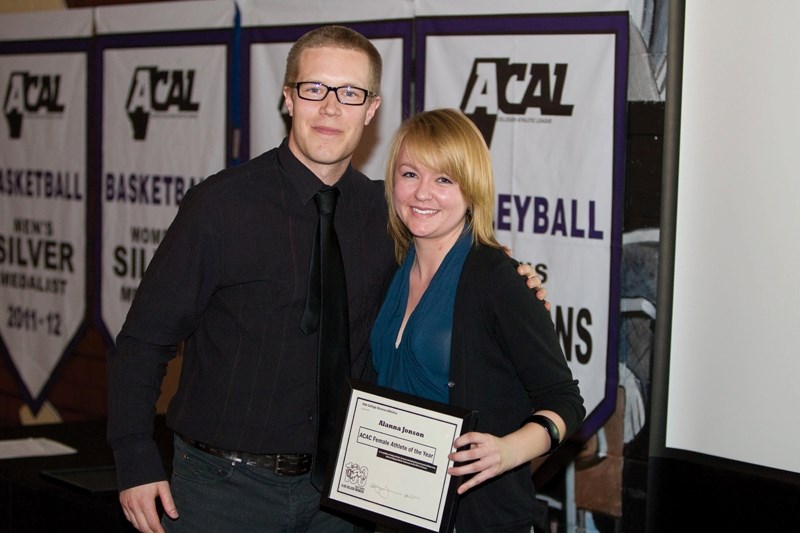Men&#8217;s volleyball coach John Riemersma presents Alanna Johnson with the ACAC Female Athlete of the Year during the awards ceremony.