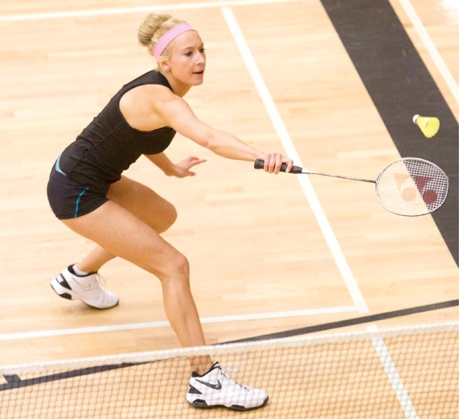 Olds High School student Sara Odersky reaches for a return shot during her match at the CESAA senior badminton tournament held at the Ralph Klein Centre in Olds last