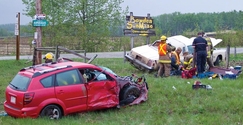Emergency responders attend to a two-vehicle collision at the intersection of Hwy. 587 and Rge. Rd. 14 last Wednesday evening.