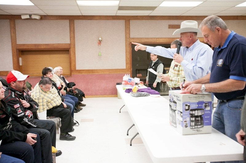 Joe Gustafson, right, marks an item while Danny Rosehill auctions off an item at the Kiwanis Fall Auction at the Royal Canadian Legion.