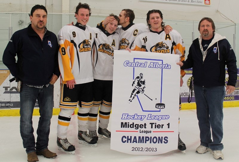 Central Alberta Hockey League vice-president Doug Durbano (left) and past-president Brian Monkman unveil the league&#8217;s championship banner to the captain and assistant
