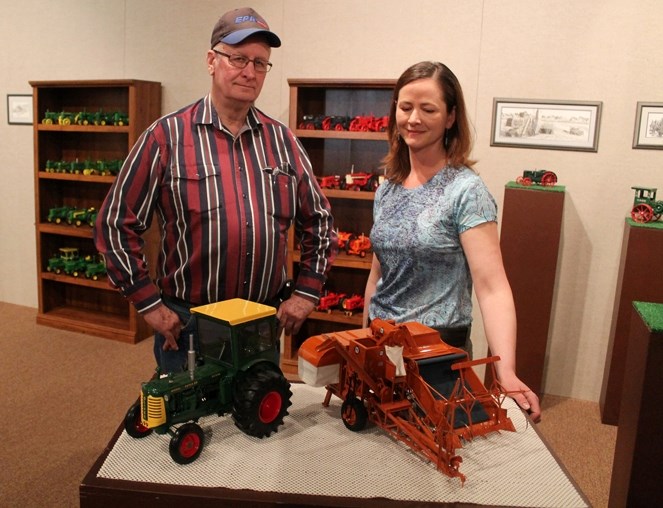 Reid Thompson, a farmer from Olds, stands with his daughter, Michelle Jorgensen, who is a curator and administrative assistant at the Mountain View Museum, among a collection 