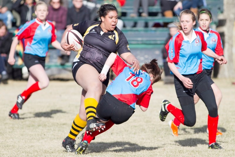 An Olds High School Spartans player runs through a Rimbey Spartans player during their game in Olds on May 1.