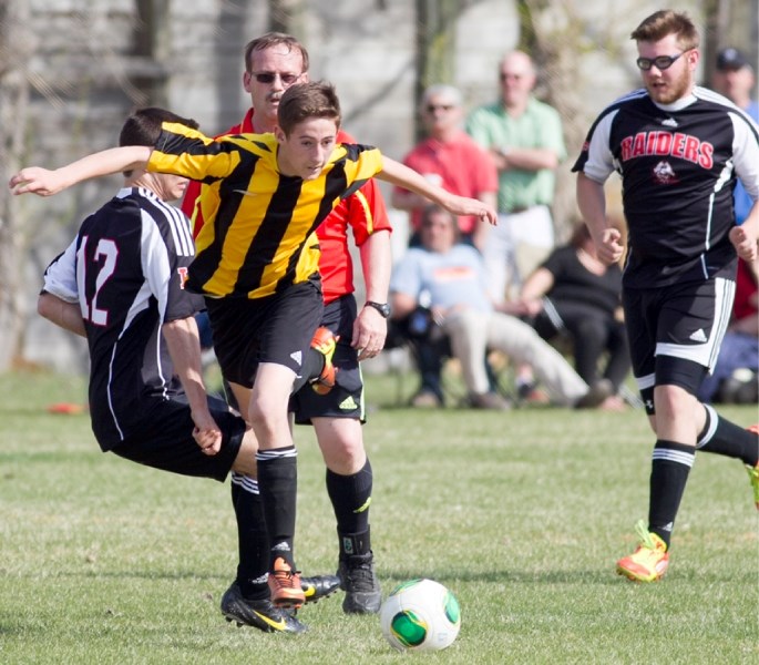 Olds High School Spartans player Talon Grenier fights for possession of the ball during the Spartans game against Lindsay Thurber Comprehensive High School Raiders at Olds