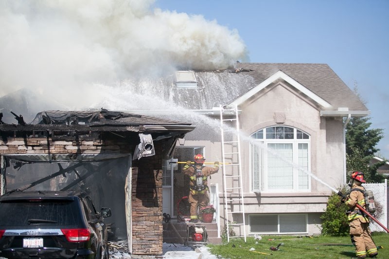 Firefighters battle a blaze that destroyed most of this home on Park Lane on the afternoon of July 1.