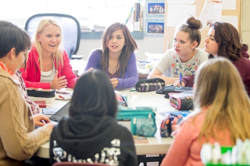 Mindy Grover, executive director of the Olds Boys and Girls Club chats with club members at Ecole Deer Meadow School.