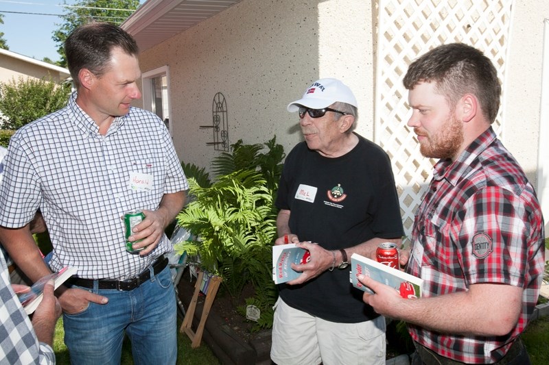 Team Norway members Harald Bøhnsdalen, left, and Kjarten Trane Skadsem, right, speak with Mel Olsen during a barbecue at Olsen&#8217;s home on July 10. Both men are entered