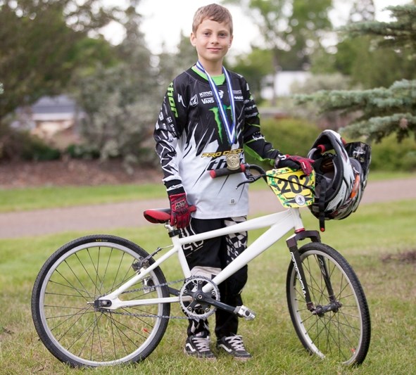 Gavin Caskey poses with his bicycle at Centennial Park on July 18.