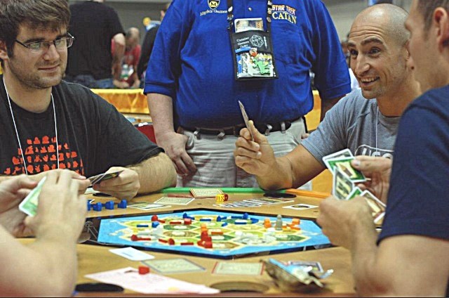 Olds&#8217; Mark Oxer (right) competes in a game of Settlers of Catan at the Gen Con 2013 gamers convention in Indianapolis earlier this month.