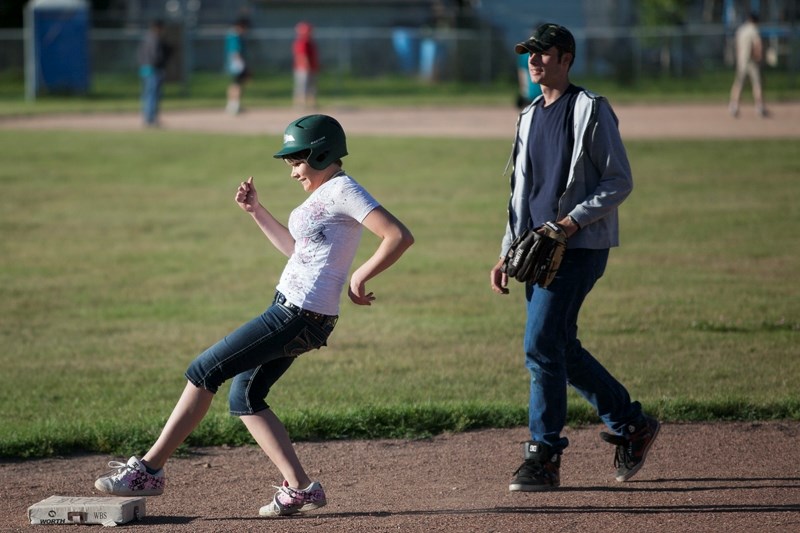 Misty Olsen touches second base during a baseball game held last month at Ecole Deer Meadow School to mark the completion of upgrades to the school&#8217;s baseball diamonds. 