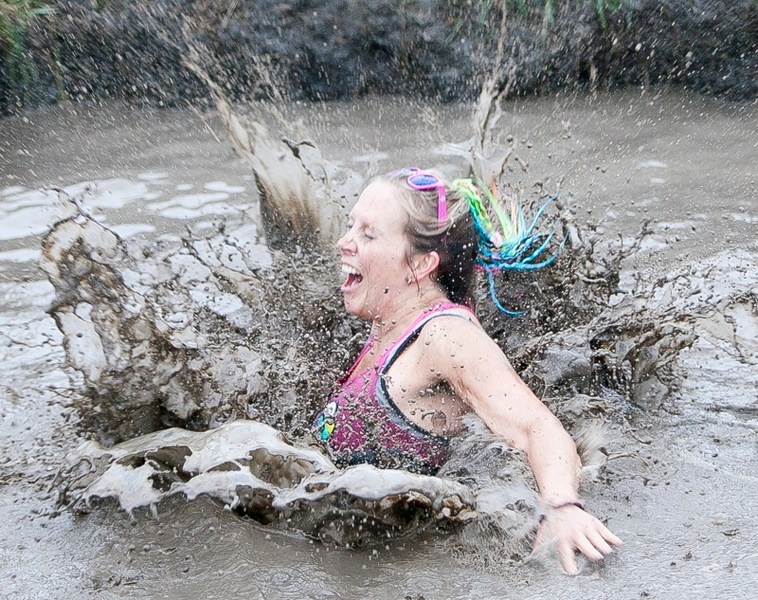 A competitor jumps into a pool of muddy water during the Community Learning Campus&#8217;s second annual Mud Run on the Olds College campus on Sept. 7. For more coverage of