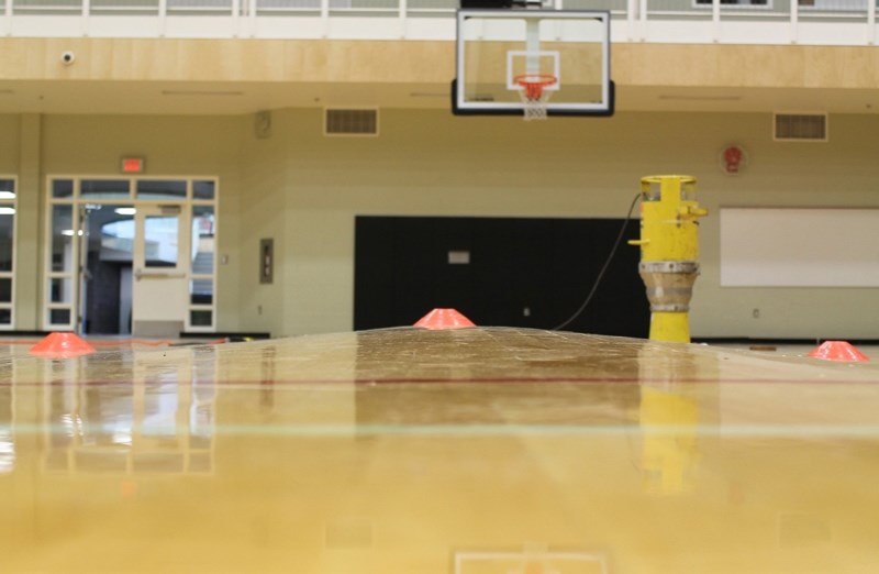 This photograph taken in July shows the buckling in the floor of the north gymnasium at the Ralph Klein Centre caused by flooding from a storm on June 29.