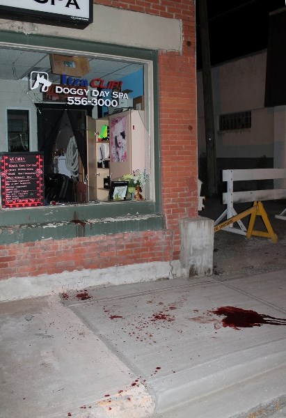 Blood is visible on the wall and sidewalk below a window that was smashed at the Itzaclip! Doggy Day Spa on 50 Street just after 11 p.m. on Sept. 21.