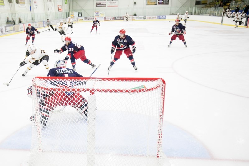 Olds Grizzlys player BJ Duffin attempts to score on the Brooks Bandits goaltender during their game at the Olds Sports Complex on Sept. 17. The Bandits won the game 7 to 3.