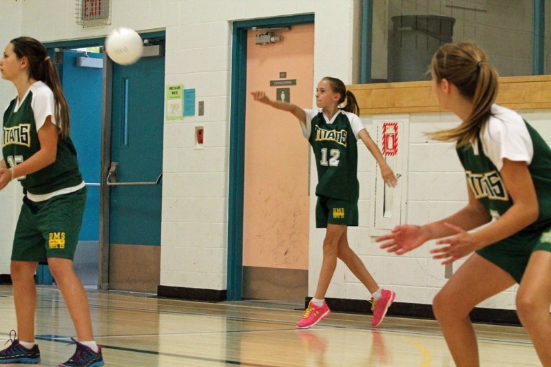Ashley Thomson, a Grade 8 student at Ecole Deer Meadow School, serves to the opposing Three Hills School Royals during the Olds College Broncos Junior High Volleyball