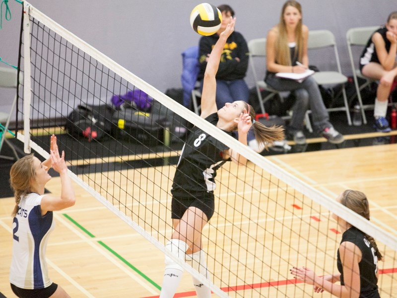 Olds High School Spartans junior varsity volleyball player Kayley Watt returns the ball during the Spartans game against the Bow Valley Bobcats during a volleyball tournament 