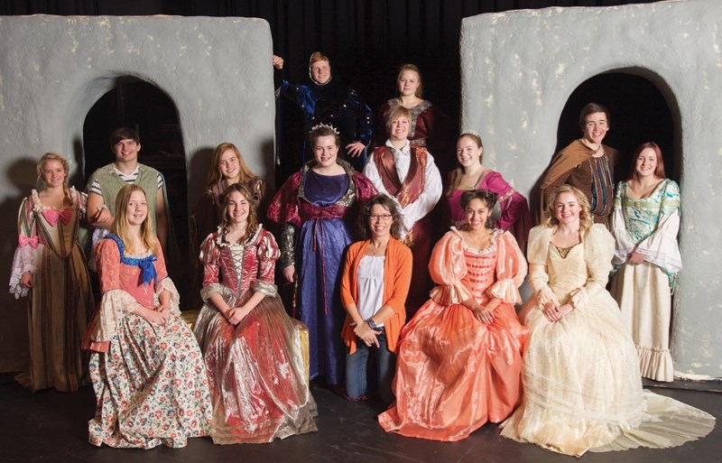 Olds High School teacher Rhonda West (middle) poses with the school&#8217;s drama club in the costumes students will wear for the school&#8217;s upcoming play, Once Upon a