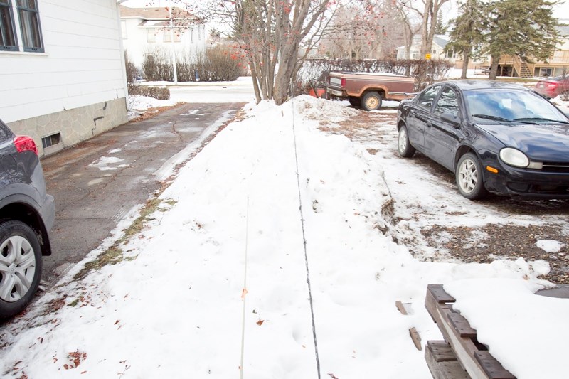 Walt Woytuck says his neighbour is piling snow to the edge of his property and some of it is being pushed onto Woytuck&#8217;s property (to the left in this photo) causing