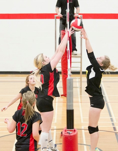 Olds High School Spartans player Veronica Pettyjohn (right) battles at the net with a Sundre High School Scorpions player during their game in Sundre on Nov. 13. The game was 