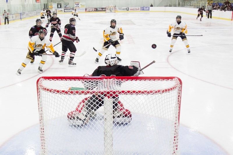 An Olds midget A Grizzlys player attempts to score on the Cochrane midget A Rockies goaltender during their game at the Olds Sports Complex on Nov. 23.