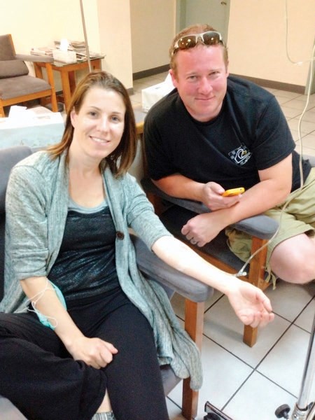Tanya Sayer receives treatment for esophageal cancer with her husband Graham at her side.